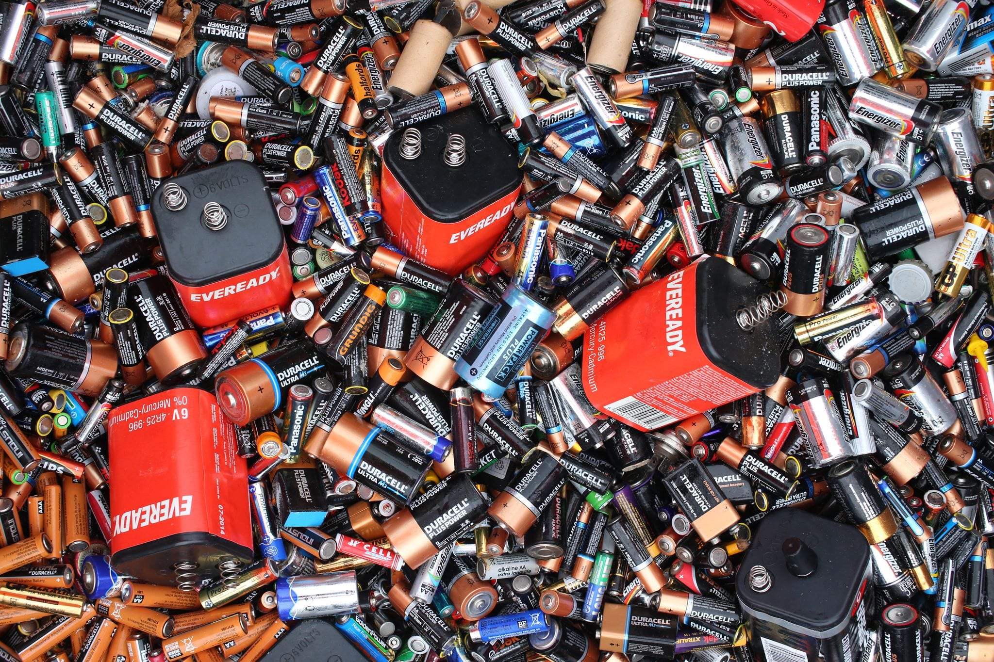 Photograph of many different types of used batteries
